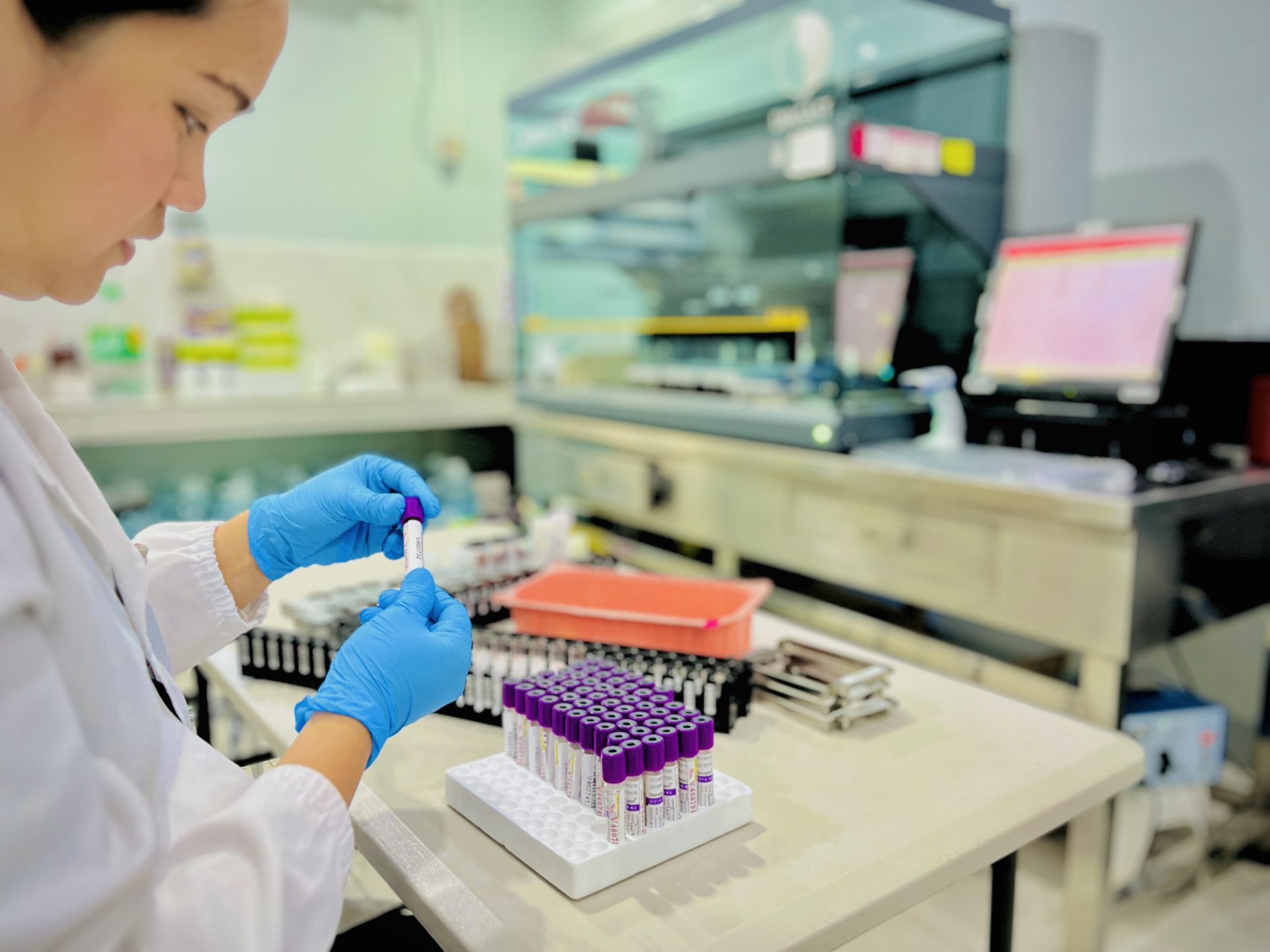 A laboratory professional preparing labeled blood samples for testing